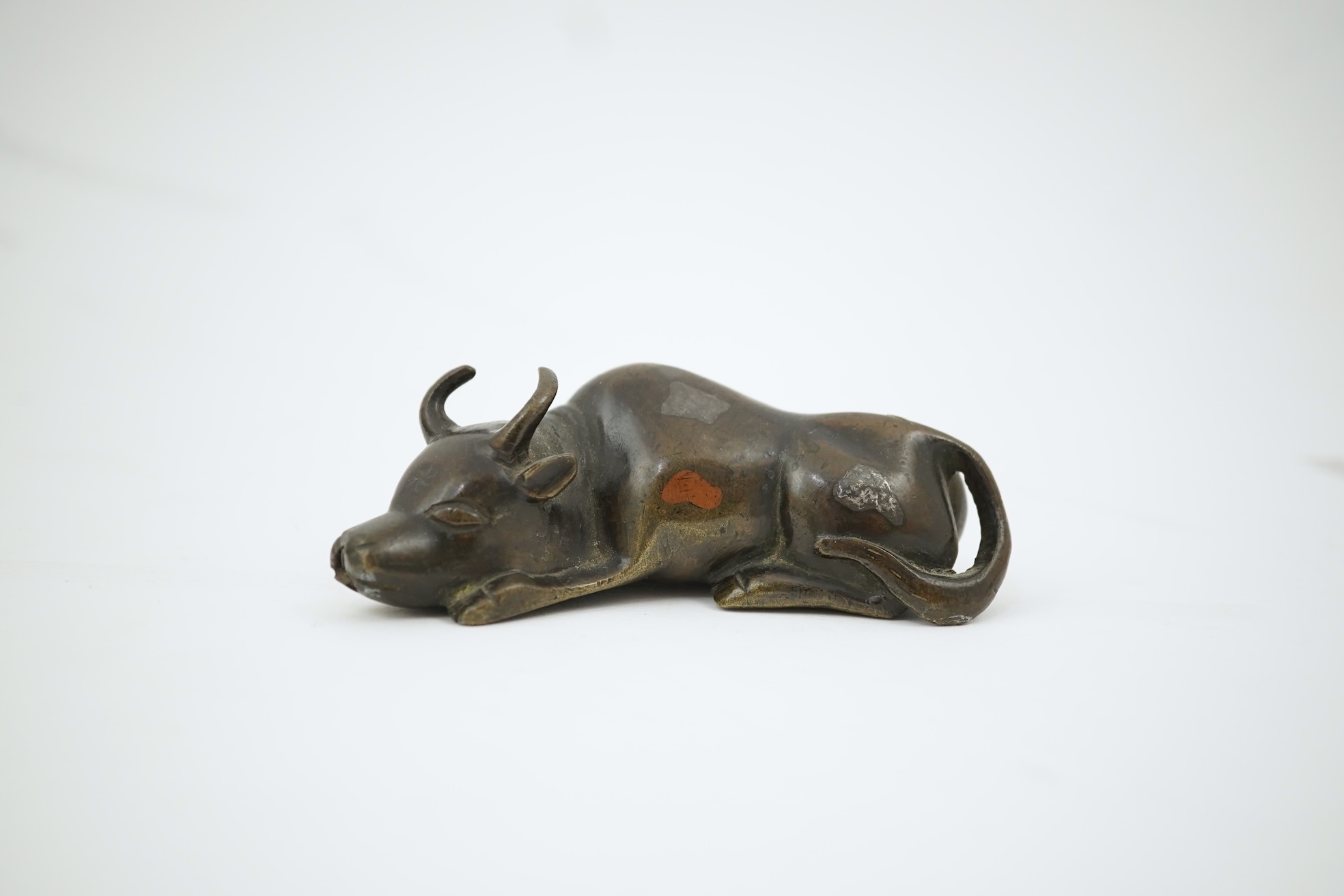 A Chinese bronze and mixed metal buffalo scroll weight, 19th century